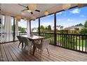 Screened-in porch featuring a dining table, chairs, and decorative lighting at 52 Summit Overlook Dr, Clayton, NC 27527