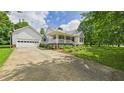 View of home with a detached garage, a basketball hoop, and an inviting front porch at 5309 Meadow Field Dr, Mebane, NC 27302