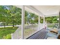 Inviting front porch with seating, plants and a nautical-themed decoration at 5309 Meadow Field Dr, Mebane, NC 27302
