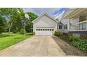 A detached garage with a basketball hoop in the driveway offers parking and recreational opportunities at 5309 Meadow Field Dr, Mebane, NC 27302