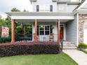 Charming home with a welcoming front porch adorned with rocking chairs and flower baskets at 604 Doddington Dr, Rolesville, NC 27571