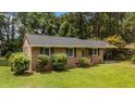 Well-maintained single story brick home with an adjacent covered carport and a mature, landscaped front yard at 625 Powell Dr, Rocky Mount, NC 27803
