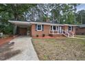 Lovely brick house with attached carport and manicured landscaping at 813 Burton St, Rocky Mount, NC 27803