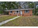 Beautiful brick home with a well-maintained lawn and inviting front entrance steps at 813 Burton St, Rocky Mount, NC 27803
