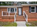 Inviting entrance with classic brick steps and decorative railing at 813 Burton St, Rocky Mount, NC 27803