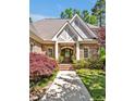 Close up of charming brick home featuring an inviting entrance with beautiful landscaping at 84307 Winslow, Chapel Hill, NC 27517