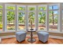 Bright sitting area with hardwood floors, large windows overlooking the green landscape at 84307 Winslow, Chapel Hill, NC 27517