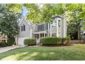 Attractive two-story gray home with well-maintained front lawn, featuring a classic design and attached garage at 9504 Anson Grove Lane Ln, Raleigh, NC 27615