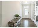 Bright foyer with hardwood floors, stylish console table, and french doors leading to other rooms at 1051 Jura Ridge Dr, Fuquay Varina, NC 27526
