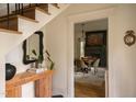 Bright foyer with black and white tile floors, decorative mirror, and a view into the dining room at 1113 Mordecai Dr, Raleigh, NC 27604