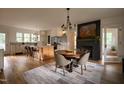Open-concept kitchen and dining area with a large island, modern appliances, and a striking fireplace at 1113 Mordecai Dr, Raleigh, NC 27604