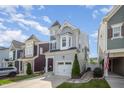 Charming two-story home with a turret, attached garage, and manicured front lawn at 1208 Brown Velvet Ln, Apex, NC 27523