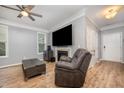 Cozy living room features a fireplace and comfortable seating with hardwood flooring at 1208 Brown Velvet Ln, Apex, NC 27523