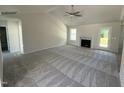 Bright living area with high ceilings, neutral paint, new gray carpet, and a cozy fireplace at 128 Oakfield Trace Dr, Four Oaks, NC 27524