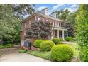 Beautiful two-story brick home with a welcoming front porch and well-manicured landscaping at 1414 Park Dr, Raleigh, NC 27605