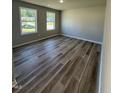 Bright bedroom with wood-style flooring and large windows that offer plenty of natural light at 154 Oakfield Trace Dr, Four Oaks, NC 27524
