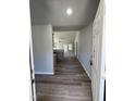 Inviting entryway with sleek wood flooring that leads into a spacious living area with neutral walls at 154 Oakfield Trace Dr, Four Oaks, NC 27524