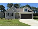 Charming single-Gathering home featuring a two-car garage, well-manicured lawn, and neutral color palette at 154 Oakfield Trace Dr, Four Oaks, NC 27524