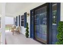 Inviting front porch with seating area and stylish blue door, enhancing curb appeal at 16 Cedar Hill Dr, Durham, NC 27713