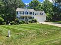 A well-maintained two story home with a green lawn and trimmed bushes at 18 Clover Hil Pl, Durham, NC 27712