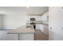 Modern kitchen with granite countertops, stainless steel appliances, and a large island with a sink at 185 Carriedelle Ln, Wilson's Mills, NC 27577
