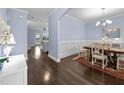 Elegant dining room with hardwood floors, chandelier lighting, and decorative wainscoting, perfect for gatherings at 20 Sweet Birch Row, Youngsville, NC 27596