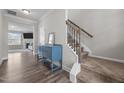Welcoming foyer featuring wood floors, an elegant staircase, and a stylish blue accent table at 2177 Campbell, Burlington, NC 27215