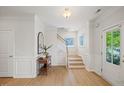 Bright foyer with hardwood floors, staircase, and elegant decor at 2713 Jazzy St, New Hill, NC 27562