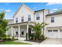 Inviting two-story home with a covered front porch, manicured landscaping and attached garage at 2713 Jazzy St, New Hill, NC 27562