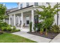 Charming front porch with cozy seating, manicured landscaping, and an inviting entrance at 2713 Jazzy St, New Hill, NC 27562