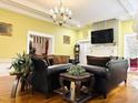 Elegant living room featuring hardwood floors, a decorative fireplace, and natural light at 275 Gholson Ave, Henderson, NC 27536