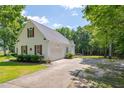 View of the home's side exterior showcasing a garage and wide driveway at 300 Williamston Ridge Dr, Youngsville, NC 27596