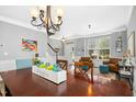 Dining room showcasing hardwood floors, a chandelier, and access to the entryway and living spaces for easy entertaining at 304 Forbes Rd, Wake Forest, NC 27587