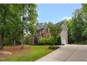 A luxurious home with a well-manicured lawn and a long driveway leading to an attached garage at 3604 Thorndike Dr, Wake Forest, NC 27587