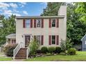 Charming two-story home with red shutters and brick steps leading to a welcoming front entrance at 3605 Iron Sight Ct, Raleigh, NC 27616