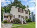 Charming two-story home with red shutters and a cozy front porch, set amidst lush greenery at 3605 Iron Sight Ct, Raleigh, NC 27616