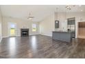 Open-concept living room featuring a fireplace, high ceilings, and hardwood floors at 3724 Stevens Chapel Rd, Smithfield, NC 27577