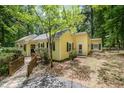 Inviting yellow home featuring a walkway and black shutters, nestled amongst lush greenery at 420 Lipscomb Grove Church Rd, Hillsborough, NC 27278