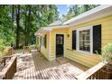 Exterior of a yellow home with black shutters and a wooden deck at 420 Lipscomb Grove Church Rd, Hillsborough, NC 27278