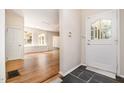 Bright foyer with hardwood floors, white trim, and a welcoming front door at 420 Lipscomb Grove Church Rd, Hillsborough, NC 27278