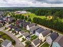 Aerial view of the neighborhood and surrounding landscape showing houses, a school and green spaces at 426 Granite Mill Blvd, Chapel Hill, NC 27516