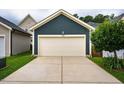Detached two car garage with concrete driveway and well maintained yard located behind the home at 426 Granite Mill Blvd, Chapel Hill, NC 27516