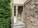 Welcoming covered front porch with stone accents and lush greenery at 4511 Crab Creek Dr # 101, Raleigh, NC 27612