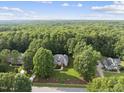 Stunning aerial view of home nestled among lush, mature trees offering privacy and serenity at 517 Belmont Cir, Wake Forest, NC 27587