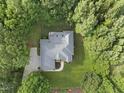 Overhead view of the house, showing the roof, lawn, driveway, and mature surrounding foliage at 517 Belmont Cir, Wake Forest, NC 27587