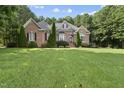 Well-maintained brick home featuring manicured lawn and beautiful landscaping at 517 Belmont Cir, Wake Forest, NC 27587
