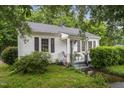 Quaint single-story home with a welcoming front porch and lovely green landscaping and trees at 520 Park Ave, Rocky Mount, NC 27801