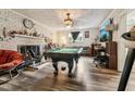 Inviting game room featuring a pool table, fireplace, and updated flooring at 520 Park Ave, Rocky Mount, NC 27801