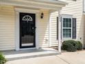 Close-up of front door with a black frame, a side window, and clean landscaping at 5225 Big Bass Dr, Raleigh, NC 27610