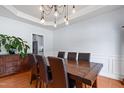 Elegant dining area featuring a wooden table, stylish chairs, and modern lighting at 534 Siltstone Pl, Cary, NC 27519